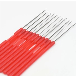 May include: A collection of red-handled latch hooks, arranged diagonally against a white background. The hooks are made of silver-colored metal and are designed for rug hooking, latch hooking, or other craft projects. The handles are a bright, solid red.