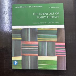 May include: A textbook titled "The Essentials of Family Therapy" by Michael P. Nichols and Sean D. Davis. The cover features a green and white header with the text "7th Edition." The book has a woven pattern of green, brown, and pink rectangles.