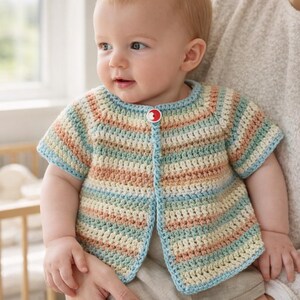 May include: A pastel-striped crochet baby cardigan with short sleeves. The cardigan features a single red button and is made in shades of blue, peach, and cream. The handmade garment is suitable for a newborn or infant.