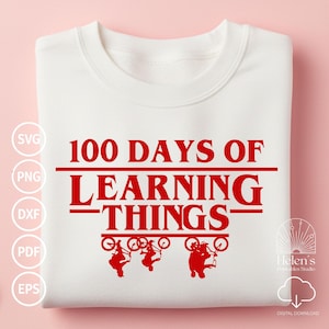 以下が含まれることがあります： 「100 Days of Learning Things」の赤い文字と3人のサイクリストのグラフィックが特徴の白いスウェットシャツ。デザインには、販売者のロゴとデジタルダウンロード情報が含まれています。