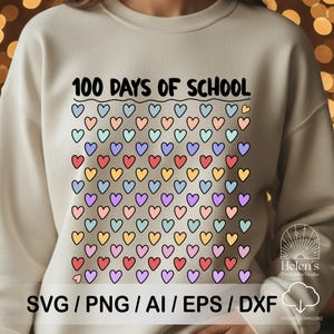 May include: Cream-colored sweatshirt with the text "100 DAYS OF SCHOOL" above a grid of colorful hearts. The hearts are outlined in black and filled with various colors. The bottom of the sweatshirt has the text "SVG / PNG / AI / EPS / DXF".