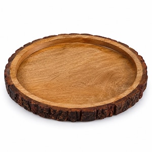 May include: A round wooden tray with a smooth, light brown interior surface and a raised rim. The exterior edge of the tray features a dark, textured, natural bark finish, showcasing the raw and organic appearance of the wood grain and texture.