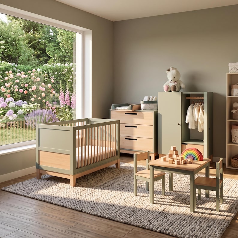 May include: A nursery room with sage green and natural wood furniture. The room includes a crib, dresser, wardrobe, small table, and chairs. A plush teddy bear sits atop the wardrobe. A large window offers a view of a garden.