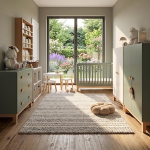 May include: A nursery room with sage green furniture, including a crib, dresser, and wardrobe. A white rug and a small table and chairs are in the center. A large window offers a view of a lush garden. A stuffed bunny sits on the dresser.
