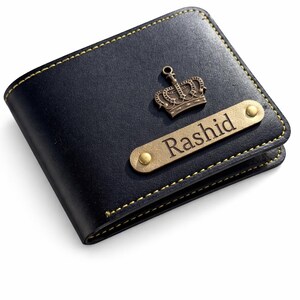 May include: Black leather wallet with gold stitching and a gold crown emblem. A gold nameplate reads "Rashid". The wallet is a bi-fold style.