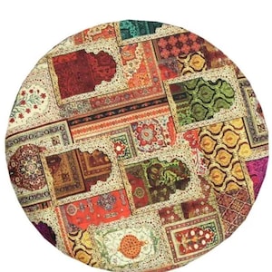 May include: A round, patterned rug featuring a patchwork design of various rectangular and square rug patterns. The rug showcases a vibrant mix of colors, including red, orange, green, and cream, with intricate floral and geometric motifs.