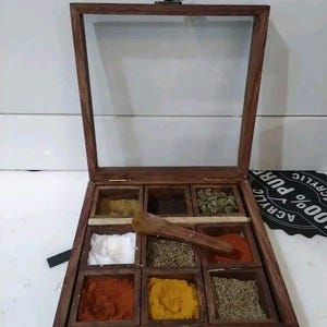 May include: A handmade, wooden serving tray with a natural finish. The tray features a rectangular shape with raised edges and two handles. The wood grain is visible, adding to its rustic charm. Dimensions are approximately 16 inches long and 10 inches wide.