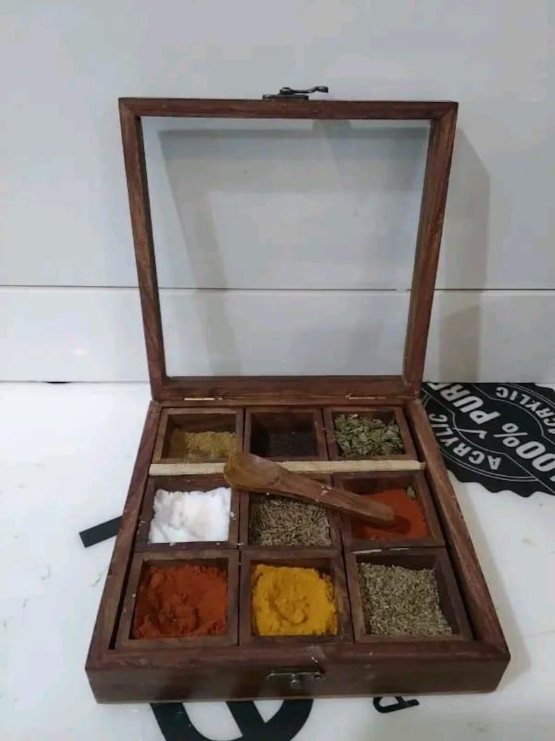 May include: A handmade, wooden serving tray with a natural finish. The tray features a rectangular shape with raised edges and two handles. The wood grain is visible, adding to its rustic charm. Dimensions are approximately 16 inches long and 10 inches wide.