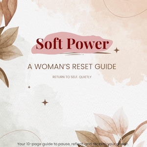 May include: A soft-toned cover with the title "Soft Power" in burgundy script. The subtitle reads "A Woman's Reset Guide." The image includes floral and leaf illustrations in shades of brown and beige. Text at the bottom reads, "Your 10-page guide to pause, reflect, and reclaim your power."
