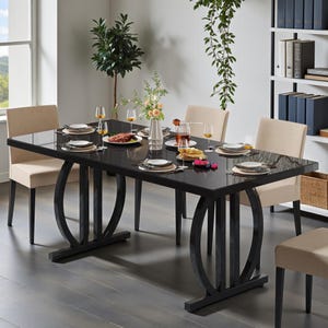 May include: A black rectangular dining table with a glossy finish, set for a meal. The table has a unique base design and is surrounded by beige upholstered chairs. The table is set with plates, glasses, and food, creating a dining room scene.