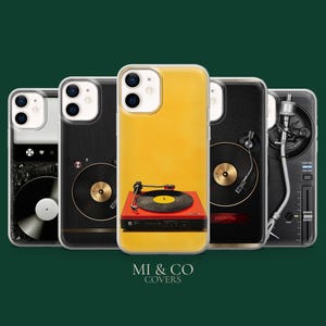 May include: A collection of phone cases featuring turntable designs. The cases showcase a variety of styles, including a red turntable with a yellow record, a black leather-textured case, and cases with graphic designs. The cases are branded with the text "MI & CO COVERS".