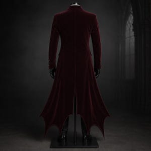 Premium Dracula Coat Gothic Costume crafted from rich wine-red velvet with a fitted Victorian silhouette, luxurious patterned waistcoat, satin lapels, elegant tie, and long bat-inspired tailcoat. Designed for Vampire Style Long Coat Masquerade Halloween outfits, gothic groom fashion, cosplay conventions, Renaissance festivals, vampire-themed photography, stage performances, and sophisticated dark formal occasions.
