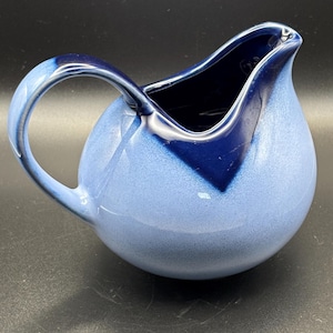 May include: A set of three ceramic mugs with a speckled, matte finish. The mugs are in shades of cream, light brown, and dark brown. Each mug has a simple, minimalist design, perfect for coffee or tea.