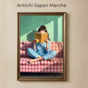 May include: Framed artwork depicting a person in blue pajamas reading a book while seated on a red and white checkered sofa. The person holds a yellow cup. The background is green with a shadow. The text "Antichi Sapori Marche" is at the top.
