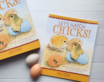 May include: Two colorful children's books with the title "Let's Hatch Chicks!" and illustrations of chicks hatching from eggs. The books are on a white surface with two brown eggs.