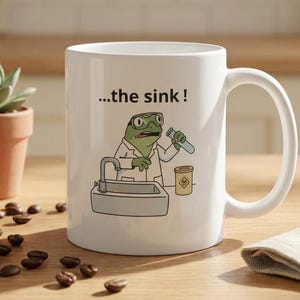May include: A white ceramic mug with a black handle and the text "But First, Coffee" in a black, bold font. The mug is on a white surface. The mug is approximately 4 inches tall.