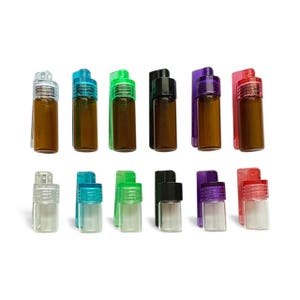 May include: A selection of small glass vials with coloured caps and clips. The vials are amber and clear, with caps in clear, blue, green, black, purple, and red. The clips match the cap colours. The vials are arranged in two rows.