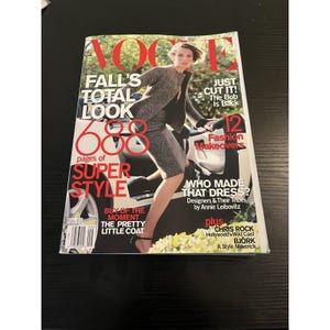 May include: A vintage Vogue magazine cover featuring a model in a gray suit. The cover includes text: "FALL'S TOTAL LOOK", "SUPER STYLE", and "Fashion Makeovers". Additional text includes "WHO MADE THAT DRESS?" and "CHRIS ROCK".