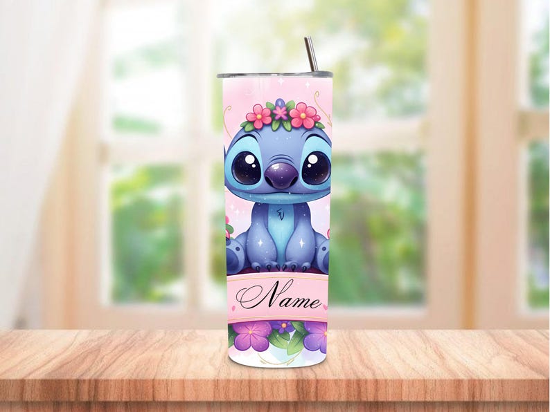 May include: A blue tumbler featuring a cartoon character with large eyes and a floral crown. The tumbler has a pink background with the character's image and the word "Name" on a banner. A straw is inserted in the lid.