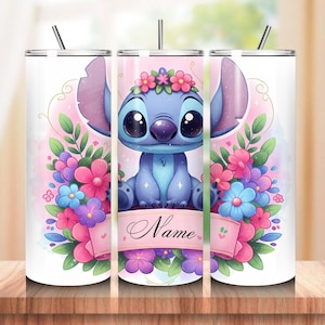 May include: A stainless steel tumbler featuring a cartoon character with large eyes, wearing a floral crown, and surrounded by flowers. The design includes a pink banner with the word "Name". The tumbler has a straw and a lid.