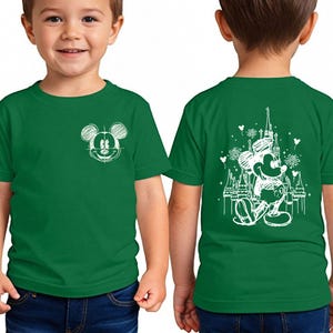 A young boy wearing a green t-shirt with a Mickey Mouse design on the front and back.