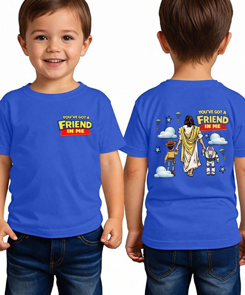 A young boy wearing a blue t-shirt with a graphic design on the back.