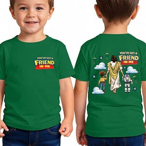 A young boy wearing a green t-shirt with a graphic design on the back.