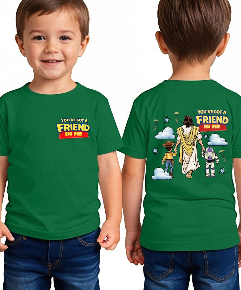 A young boy wearing a green t-shirt with a graphic design on the back.