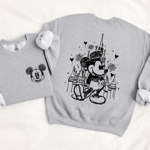 two gray sweatshirts with black and white illustrations of Mickey Mouse and a castle.