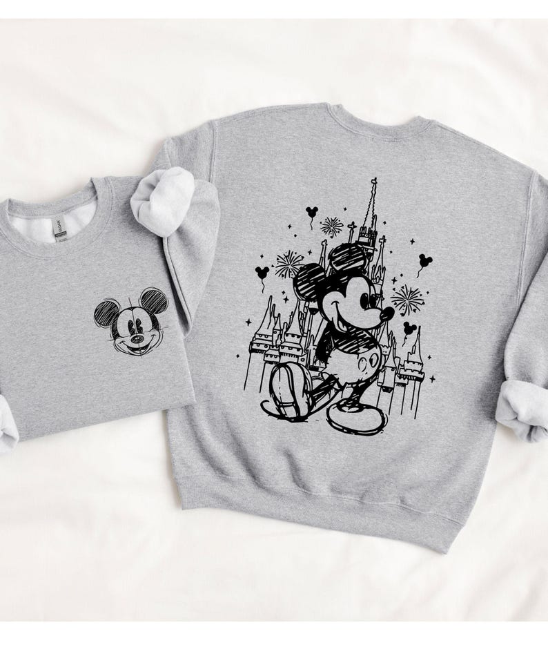 two gray sweatshirts with black and white illustrations of Mickey Mouse and a castle.