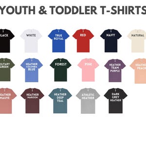 a collection of 16 different youth and toddler t-shirts, each with a unique color and design. The t-shirts are arranged in a grid format, with four rows and four columns. The t-shirts are labeled with various colors and styles, such as black, white, navy, natural, military green, forest blue, pink, peach, heather maroon, heather teal, athletic heather, dark grey, and grey.