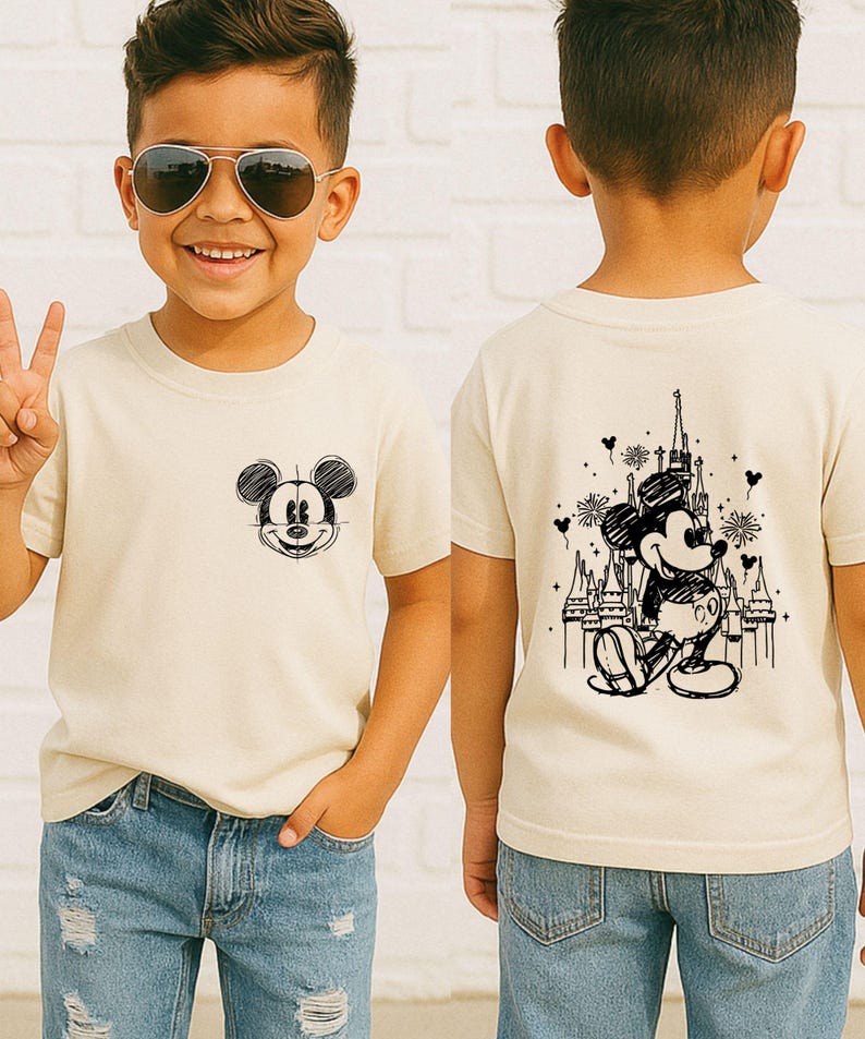 A young boy wearing a Mickey Mouse t-shirt and sunglasses, smiling and making a peace sign.