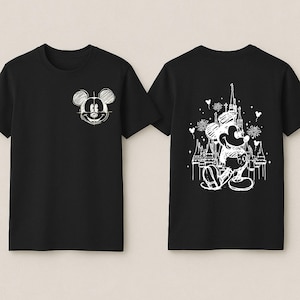 two black t-shirts with white designs on the back. The designs include Mickey Mouse and a castle.