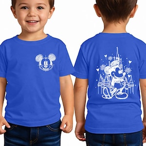 A young boy wearing a blue t-shirt with a Mickey Mouse design on the front and a castle on the back.