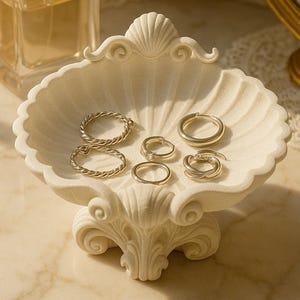 May include: A set of three ceramic mugs with a speckled, matte finish. The mugs are in shades of cream, light gray, and dark gray. Each mug has a simple, minimalist design, perfect for coffee or tea.