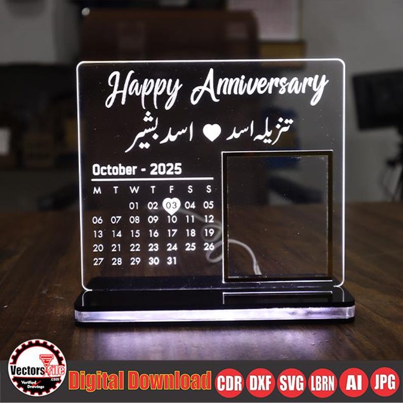 May include: A clear acrylic anniversary calendar with the words "Happy Anniversary" and a calendar for October 2025. The calendar includes a photo frame and is illuminated by a white light.