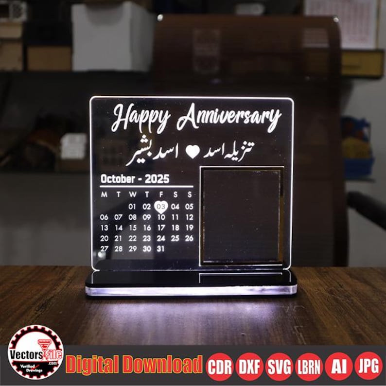 May include: A black acrylic anniversary calendar with the words "Happy Anniversary" and an October 2025 calendar. The calendar has a photo frame and is illuminated from the base. The text "Digital Download" is at the bottom.