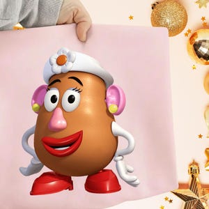 May include: A cartoon image of Mrs. Potato Head from Toy Story. She has a brown potato-shaped head, a pink nose, and red lips. She wears a white hat with a flower and pink earrings. Her arms and hands are white, and her shoes are red.