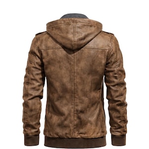 May include: Brown leather jacket with a hood. The jacket has a distressed look, with a ribbed hem and cuffs. The hood is lined with grey fabric. The jacket has a zip closure and pockets.