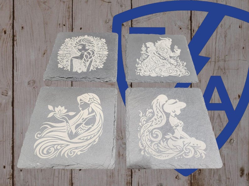 May include: Four gray slate coasters with white etched designs. Each coaster features a different princess: Elsa, Belle, Rapunzel, and Jasmine. The coasters are square with a slightly angled edge, perfect for drinks.