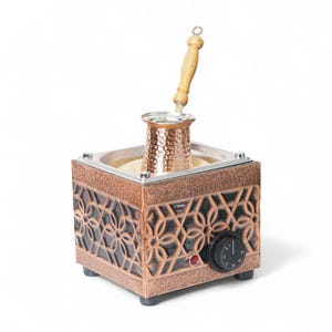 May include: A square copper-colored electric coffee sand heater featuring a geometric floral pattern on the sides, a black temperature control dial, a small red indicator light, and a hammered copper coffee pot with a light wooden handle.