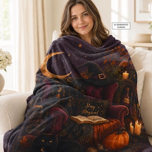 May include: A plush throw blanket featuring a dark, mystical scene with a black cat, a pumpkin, a lit candle, an open book, and a witch hat. The text "Stay Magical" is printed on the blanket, which is draped over a person sitting on a sofa.