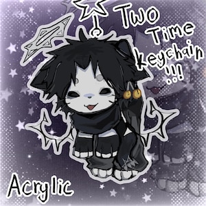 May include: An acrylic keychain featuring a cartoon cat character with black fur, a white face, and a black scarf. The keychain has the text "Two Time Keychain!!!" and "Acrylic" in white.