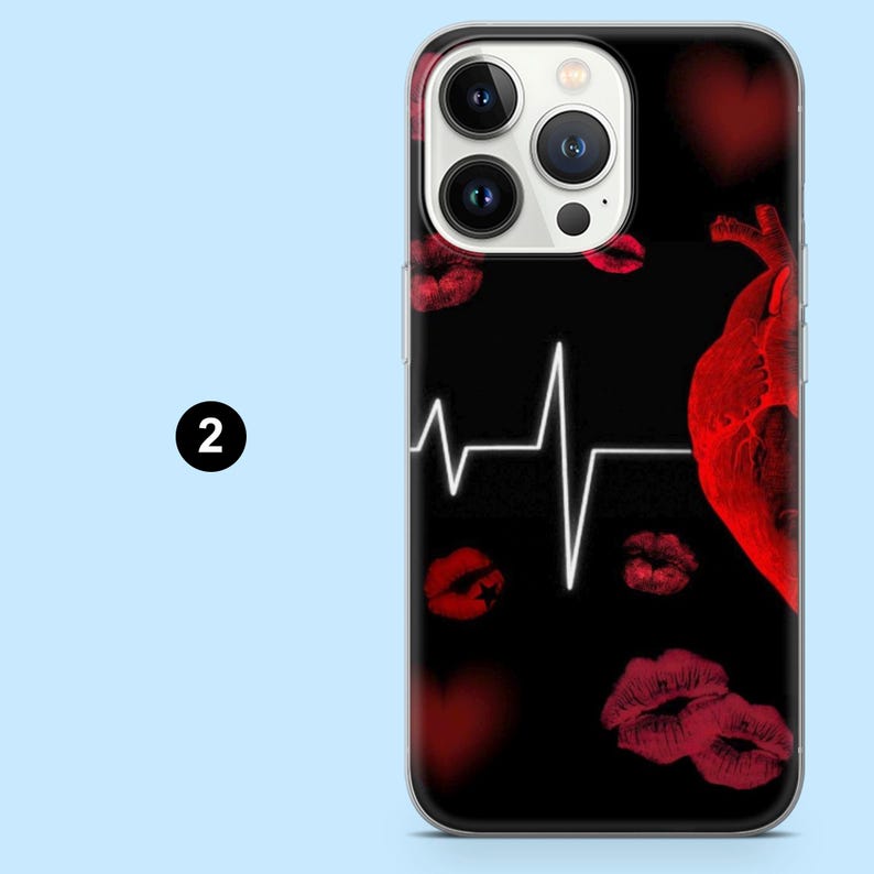 May include: Black phone case with a design featuring a red heart, red lipstick kisses, and a white heartbeat line. The case has a clear border and a camera cutout.