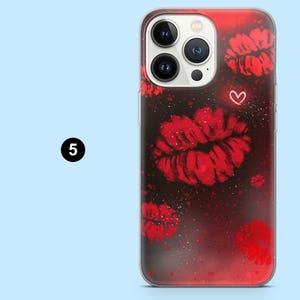 May include: A clear phone case with a red and black gradient design. The case features multiple red lip prints and a small white heart. The number "5" is in a black circle in the upper left corner.