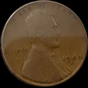 May include: A copper-coloured circular coin featuring a profile portrait of a person facing right. The text LIBERTY is visible on the left side, and the year 1940 is stamped on the right side. The coin has a smooth, raised border around the edge.