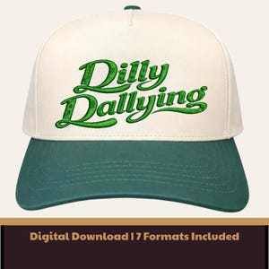 May include: A baseball cap with a cream-colored crown and a green bill. The words "Dilly Dallying" are embroidered in green script across the front. The cap has a green button on top.