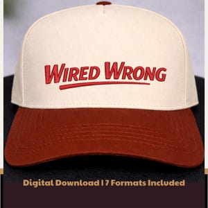 May include: A white ceramic mug with a black handle and the text "But First, Coffee" in a bold, black font. The mug is set against a blurred background, suggesting a cozy setting.