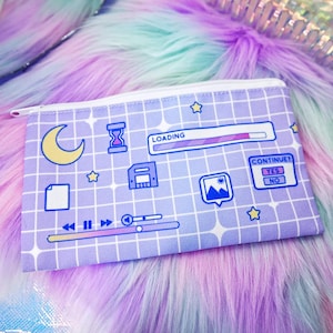 May include: A rectangular lavender pencil case with a white grid pattern and various computer-themed icons including a yellow crescent moon, an hourglass, a loading bar, a floppy disk, a document, a photo icon, and a continue prompt with yes and no.