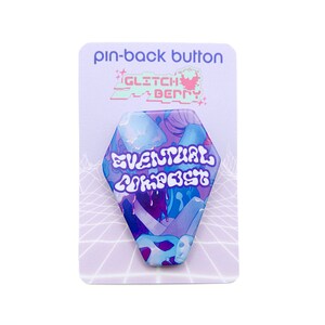 May include: A purple and blue pin-back button with a hexagonal shape. The button features a psychedelic design with mushrooms and the text "EVENTUAL COMPOST". The button is on a white background with a purple border.